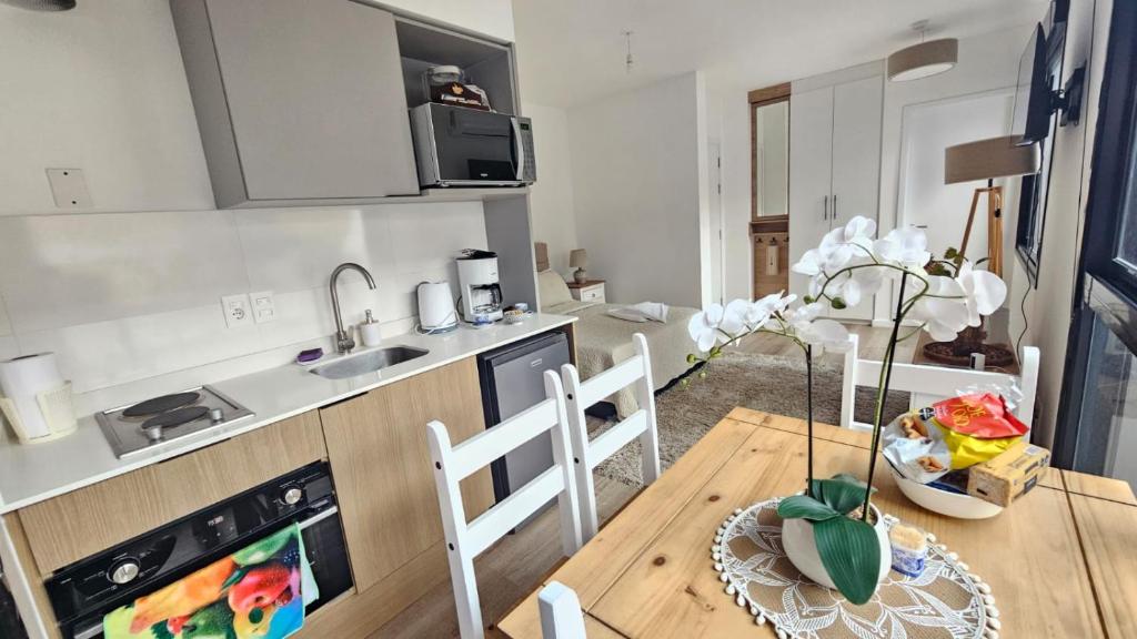 a kitchen and dining room with a wooden table at let health flow in Montevideo