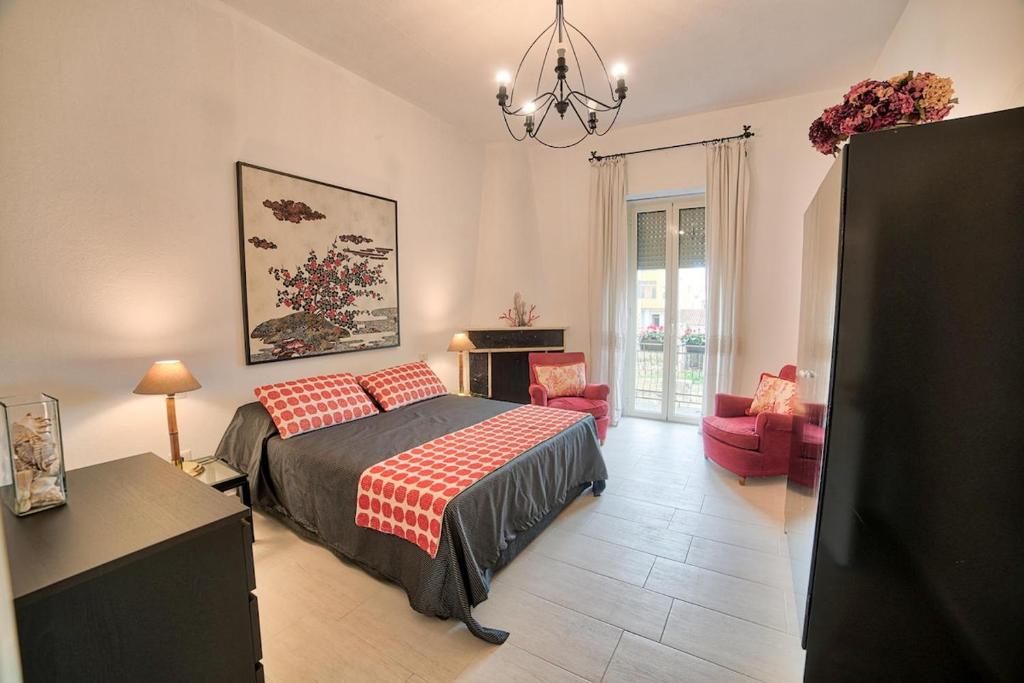 a bedroom with a bed and a living room at Lemon Home in Olbia