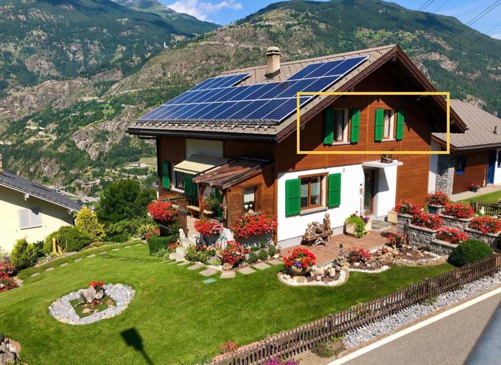 a house with solar panels on the roof at Staldenried Ferienwohnung in Staldenried