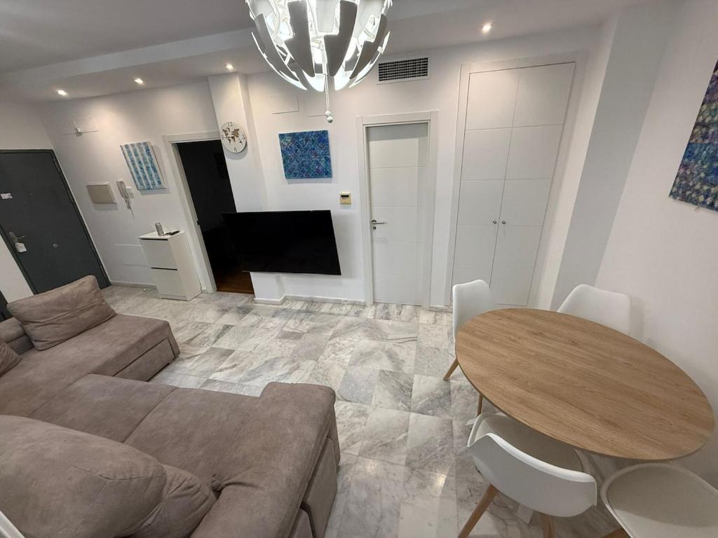 a living room with a couch and a table at Serenity Gelves in Gelves