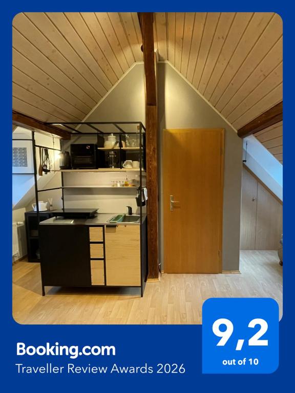 a kitchen with a stove and a refrigerator in a room at Modernes 1-Raum-Apartment in Dresden