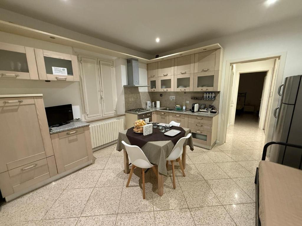 a kitchen with a table and chairs in a kitchen at Sotto il Borgo Apartments in Iesi