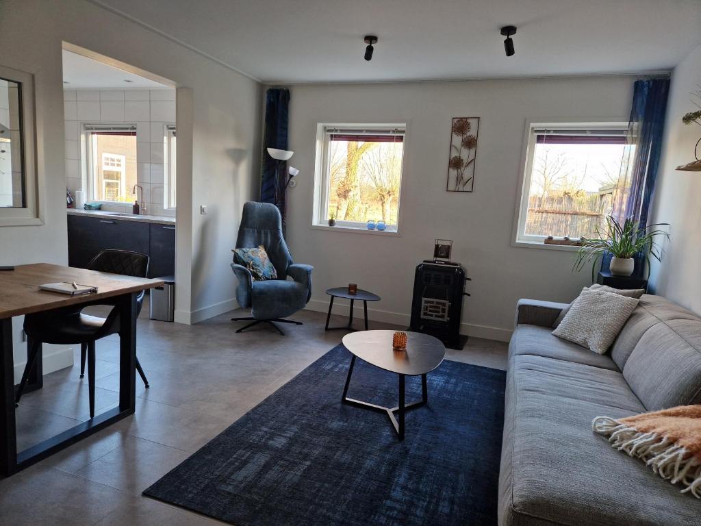 a living room with a couch and a table at Vakantiewoning "In Between" in Oostkapelle