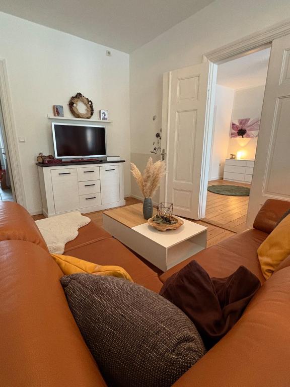 a living room with a couch and a flat screen tv at Wohnen in der ehemaligen Bauernstube in Treia