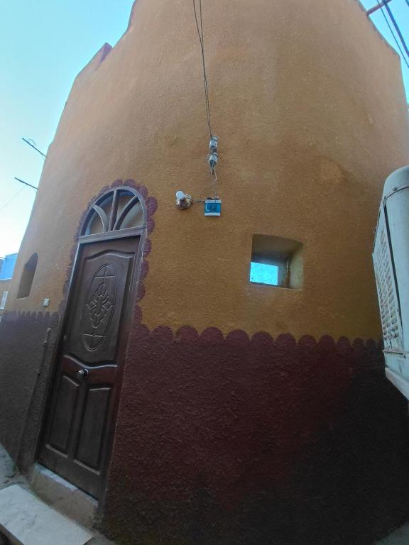 a brown building with a door and a window at moon guest house in Aswan