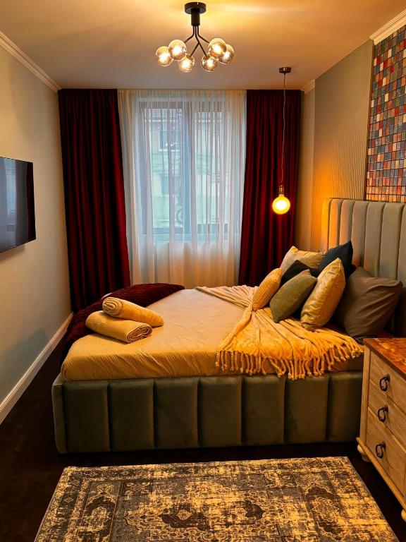 a bedroom with a large bed with pillows on it at GZP Residence Lugoj 14 in Lugoj