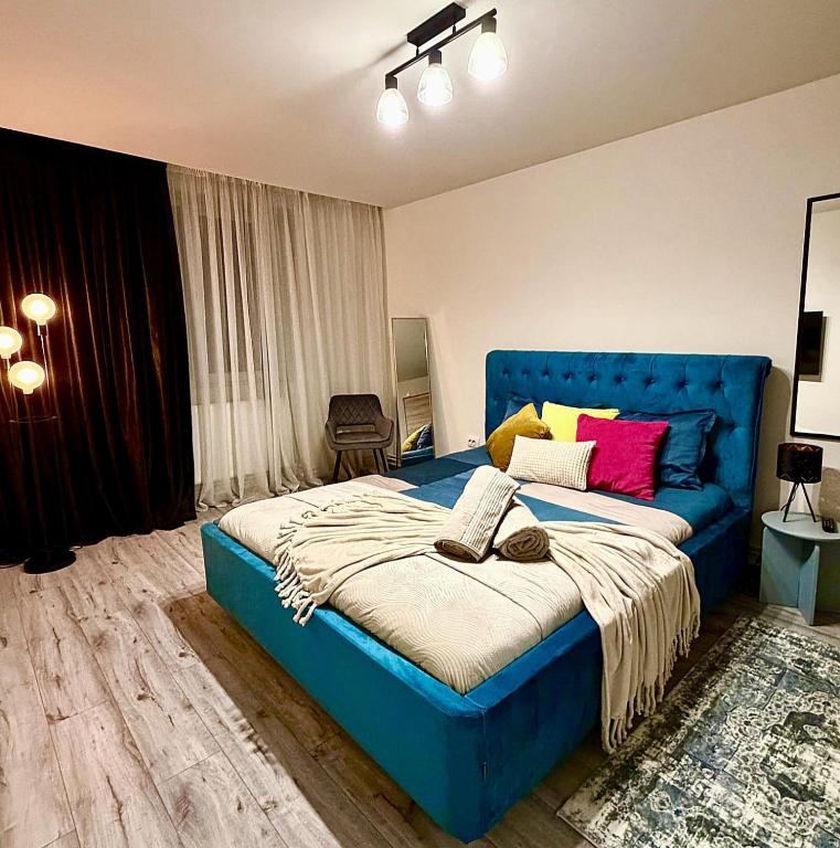 a bedroom with a blue bed with a blue couch at GZP Residence Lugoj 19 in Lugoj