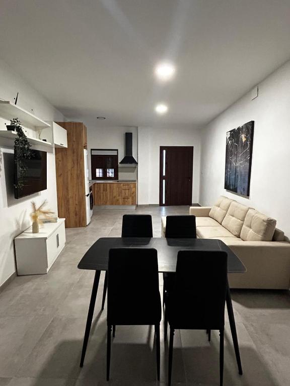 a living room with a table and a couch at MariaValiente in Montoro