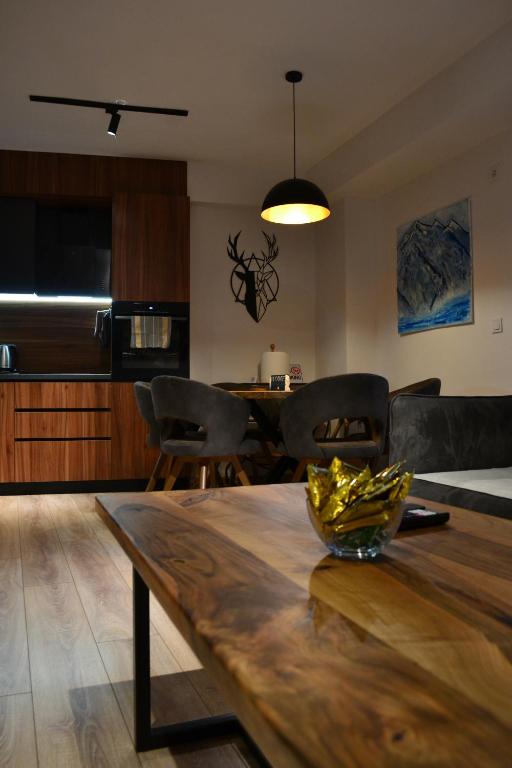 a kitchen and dining room with a wooden table at NovAS Apartment in Mavrovo