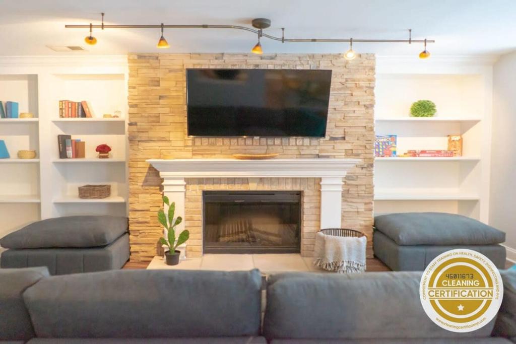 a living room with a couch and a fireplace at Lovely CWE 2BR with Private Parking ABODEbucks in Saint Louis