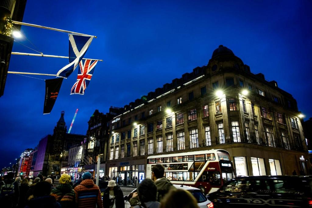 a large building with a british flag in front of it at Motel One Edinburgh-Princes in Edinburgh
