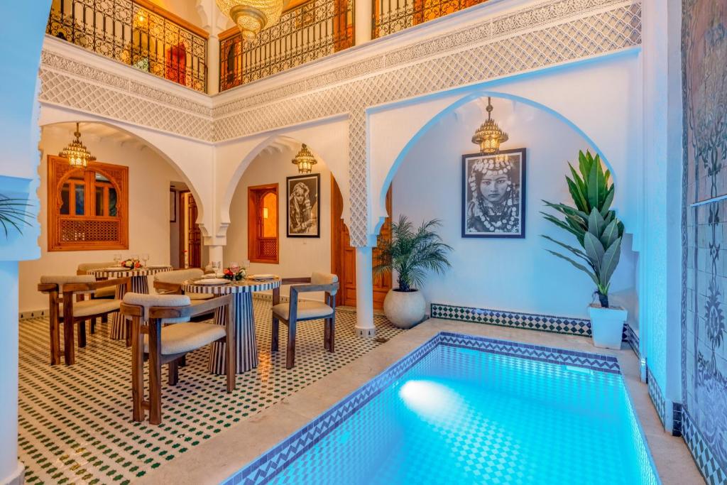 a house with a swimming pool in the middle of a room at Riad Secret De Medina in Marrakesh