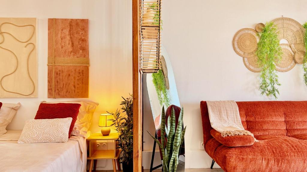 a living room with a bed and a couch at Maemora - Studio in Les Trois-Îlets