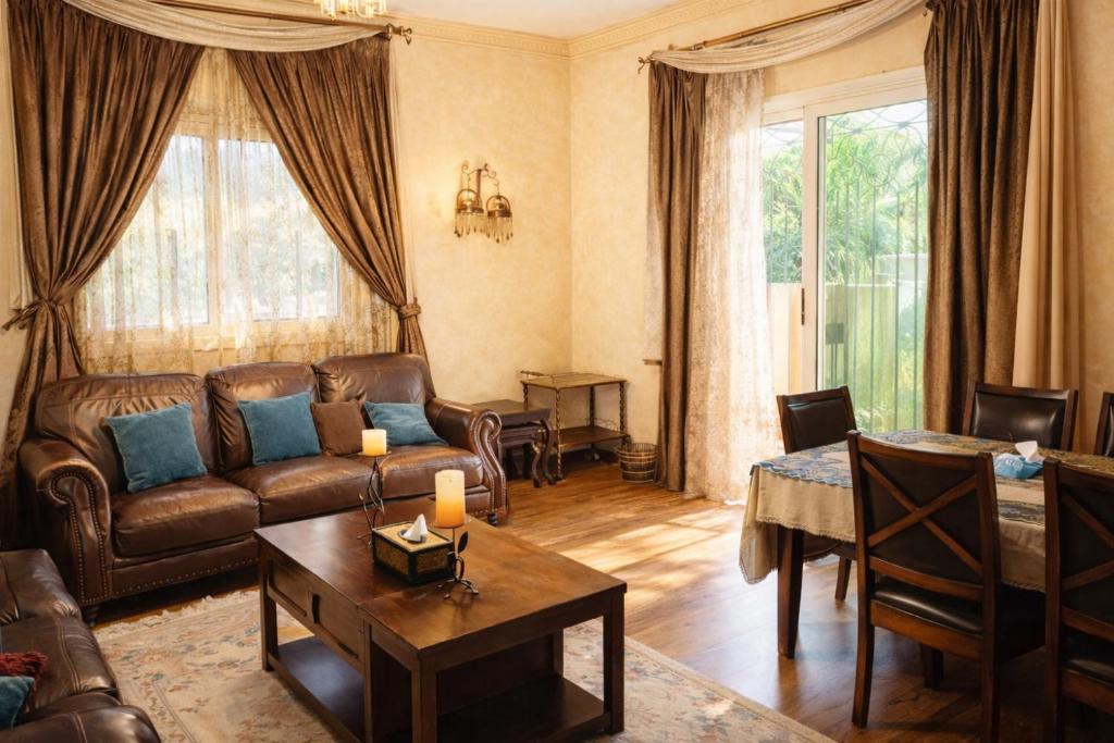 a living room with a couch and a table at The New Cairo 3BR Residence in Cairo