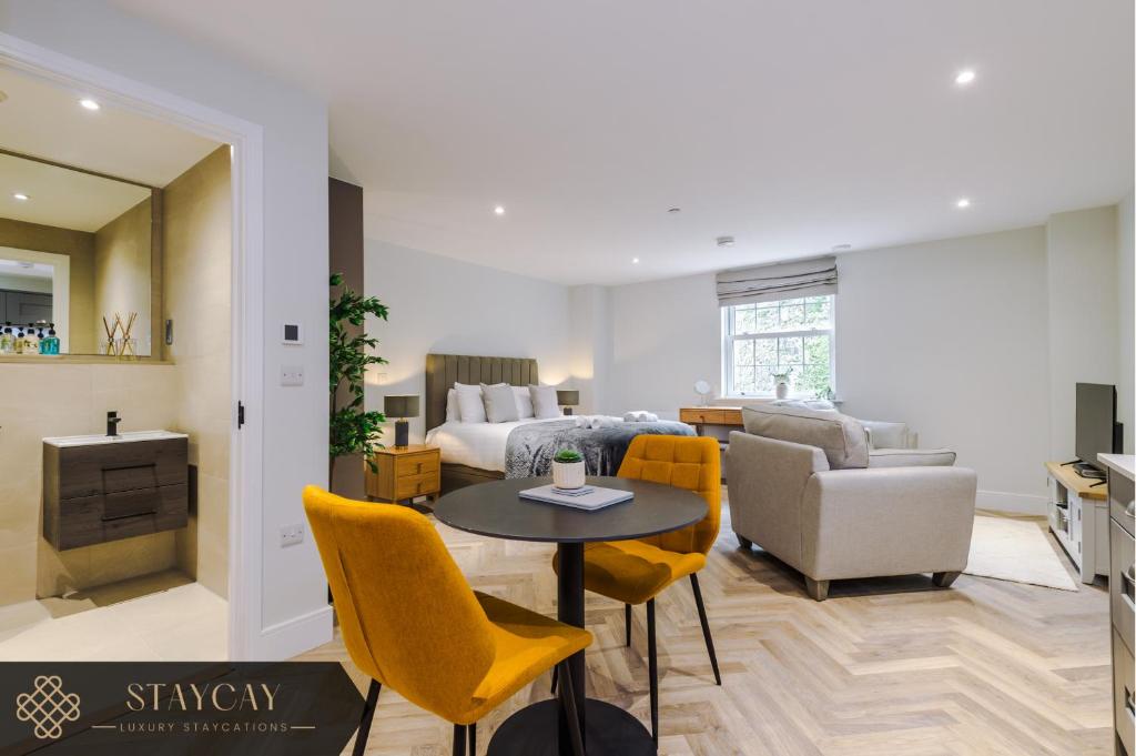a living room with a couch and a table and chairs at Rock Mill - Stunning Studio Apartment in Stony Middleton