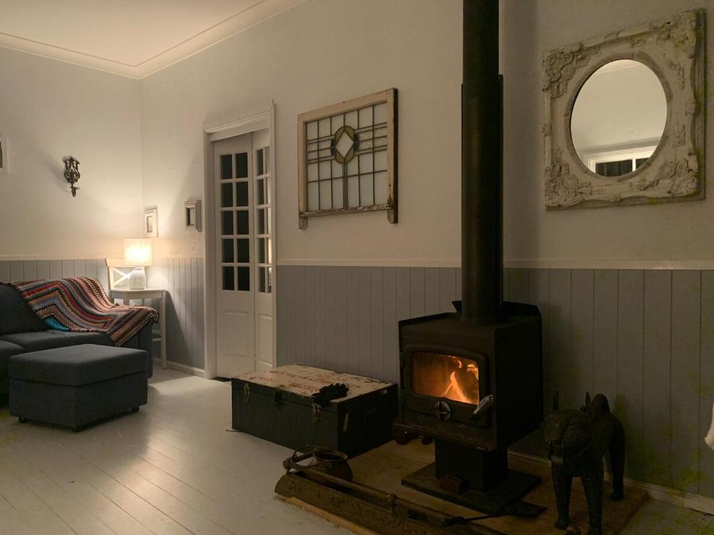 a living room with a wood stove in it at Cobargo ButterHaus in Cobargo