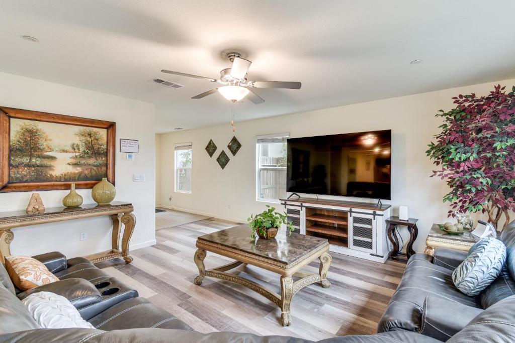 a living room with a couch and a table at Pool Table & Patio! Spacious Merced Getaway in Merced