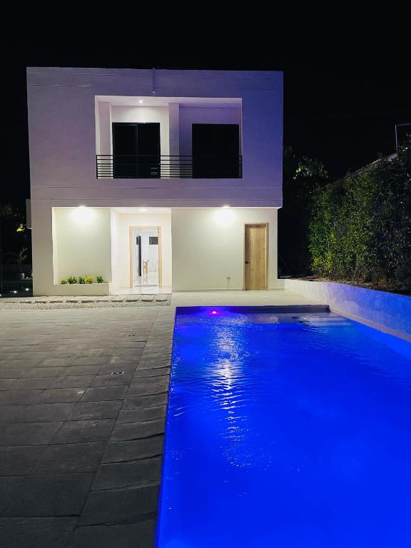 a house with a blue pool in front of it at Villa Sierra Mar in Playa Bello Horizonte