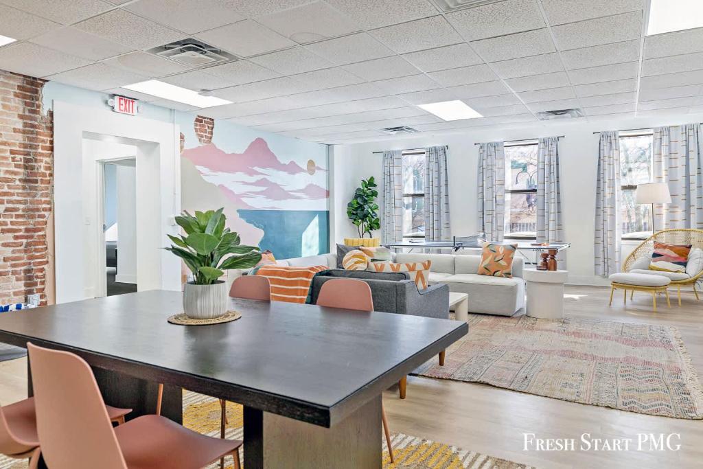 a living room with a table and chairs at City View Loft in Saint Joseph