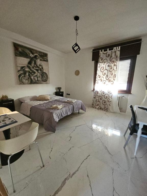 a bedroom with a bed and a table and chairs at VILLA GIOVANNA in Bergamo