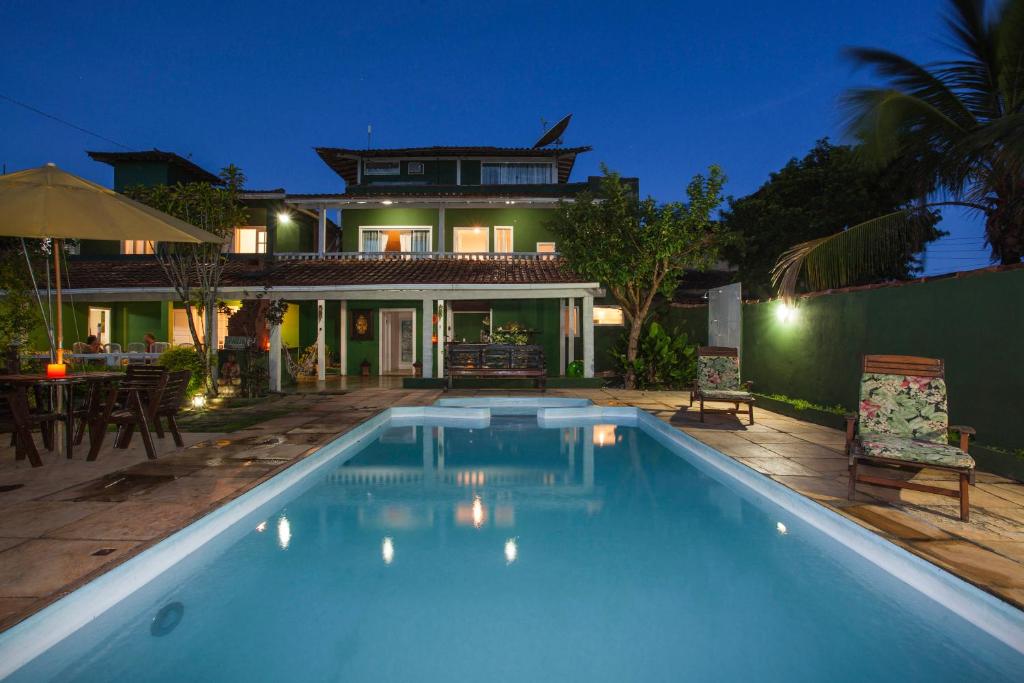 una casa con piscina frente a una casa en Spazio Buzios Guesthouse, en Búzios