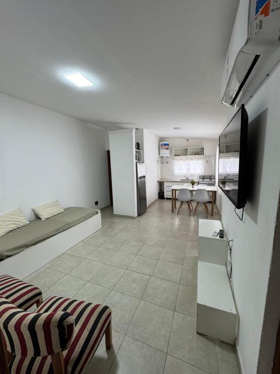 a large room with a kitchen and a living room at Casa de 2 dormitorios, zona parque in Necochea