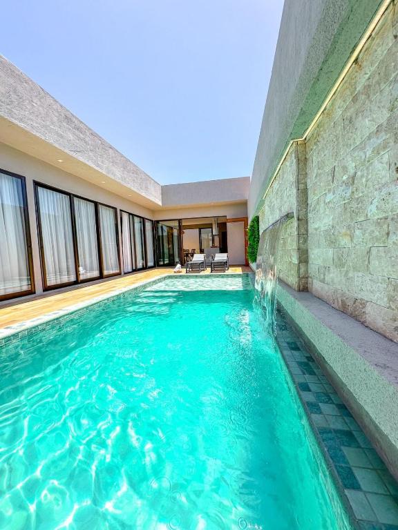 a swimming pool in the middle of a building at Casa Don Magalhães in Barra de São Miguel