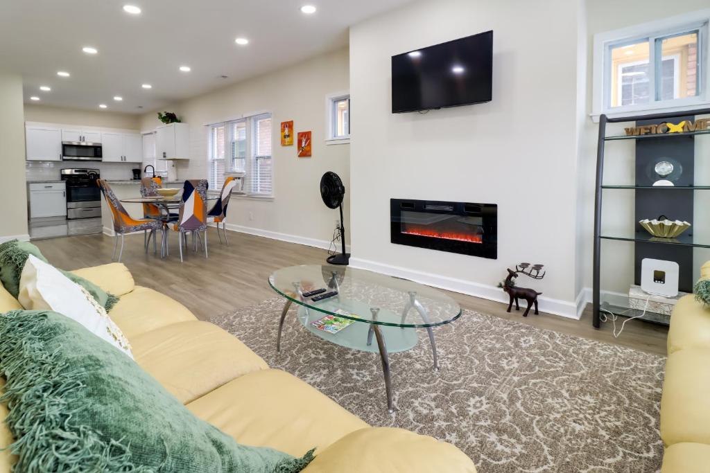 a living room with a couch and a glass table at Modern Updates & Great Location! Detroit Duplex in Detroit