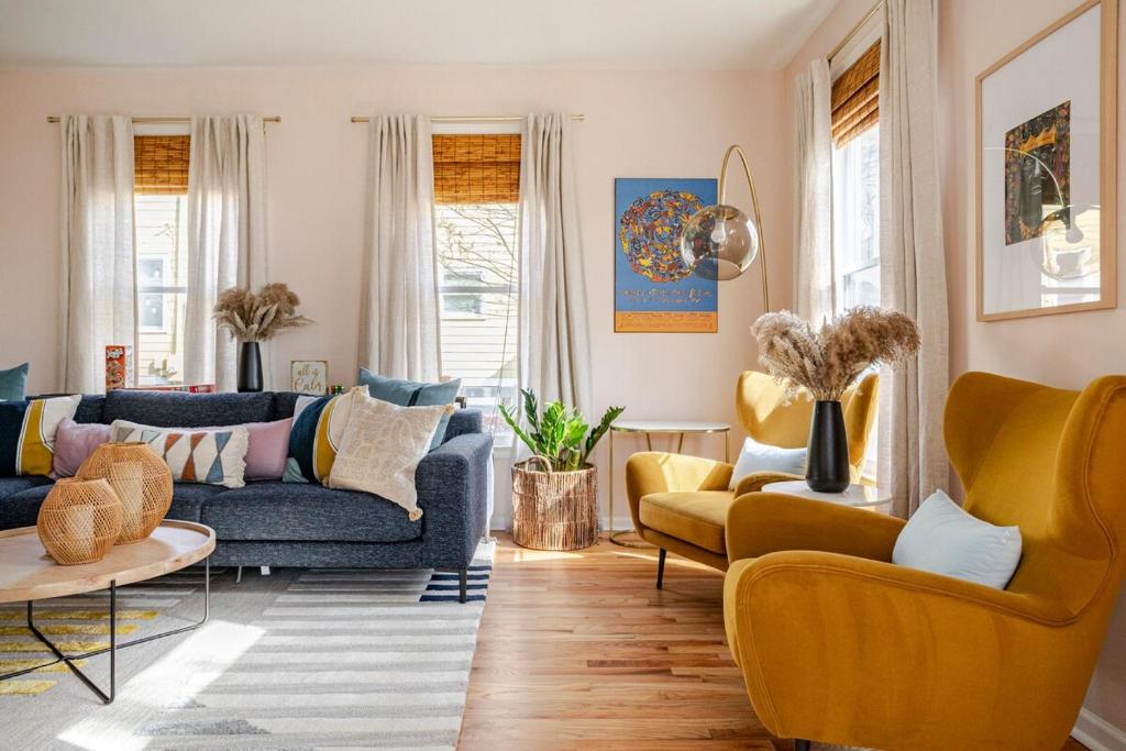 a living room with blue couches and yellow chairs at Lush, Spacious Intown Retreat in Atlanta