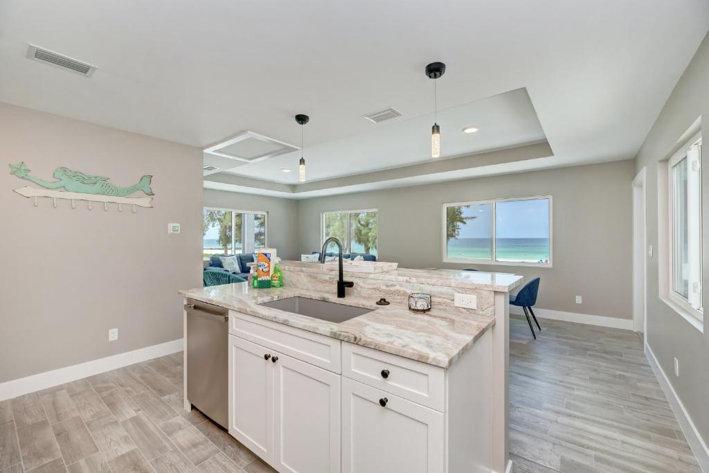a kitchen with a sink and a counter top at Ami Gulf Lookout-Views Of The Gulf From Every Room-Rooftop Terrace in Bradenton Beach