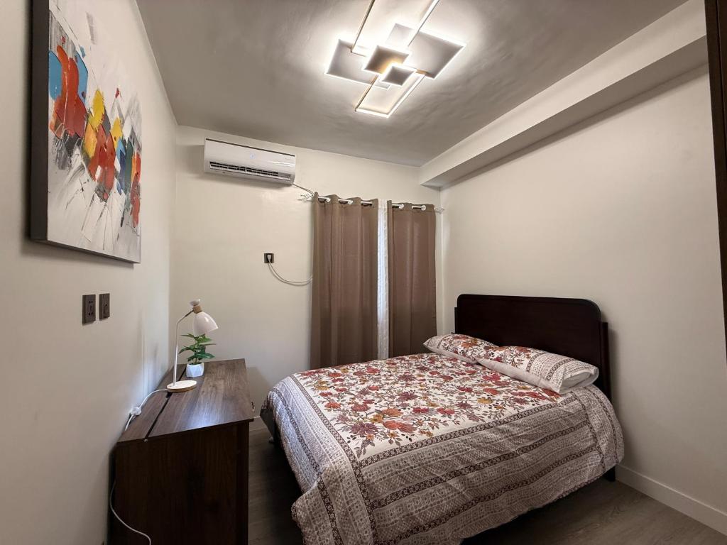 a bedroom with a bed and a dresser in it at The Infinity View in Talisay