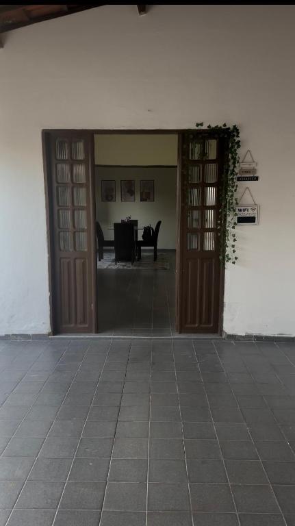 an open door to a room with a table at 3R acomodações in Juazeiro do Norte