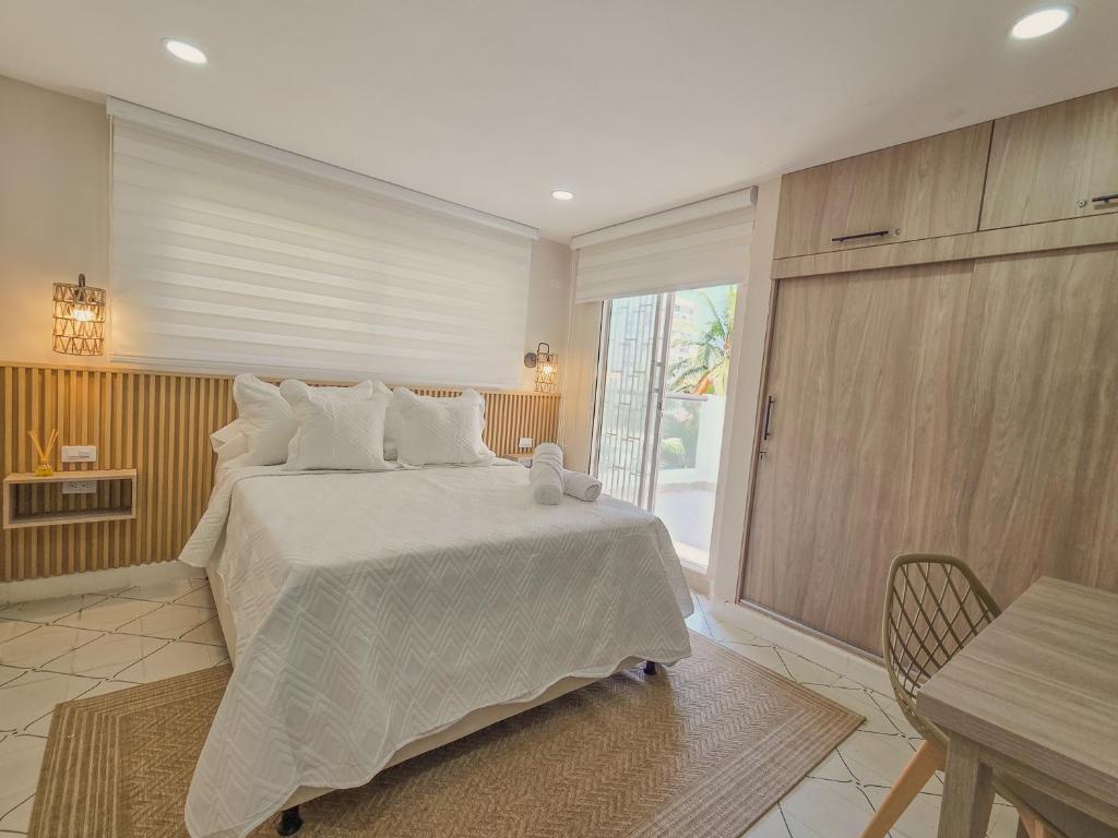 a bedroom with a large bed with white pillows at Margarita 93 in Barranquilla