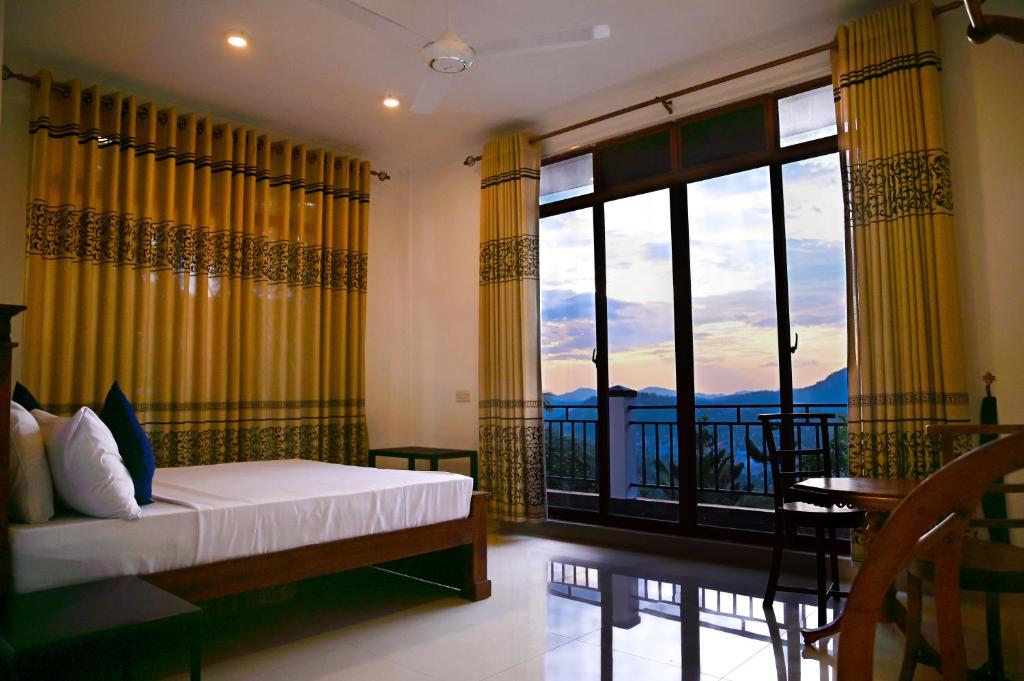 a bedroom with a bed and a window with a view at Windsor in Kandy