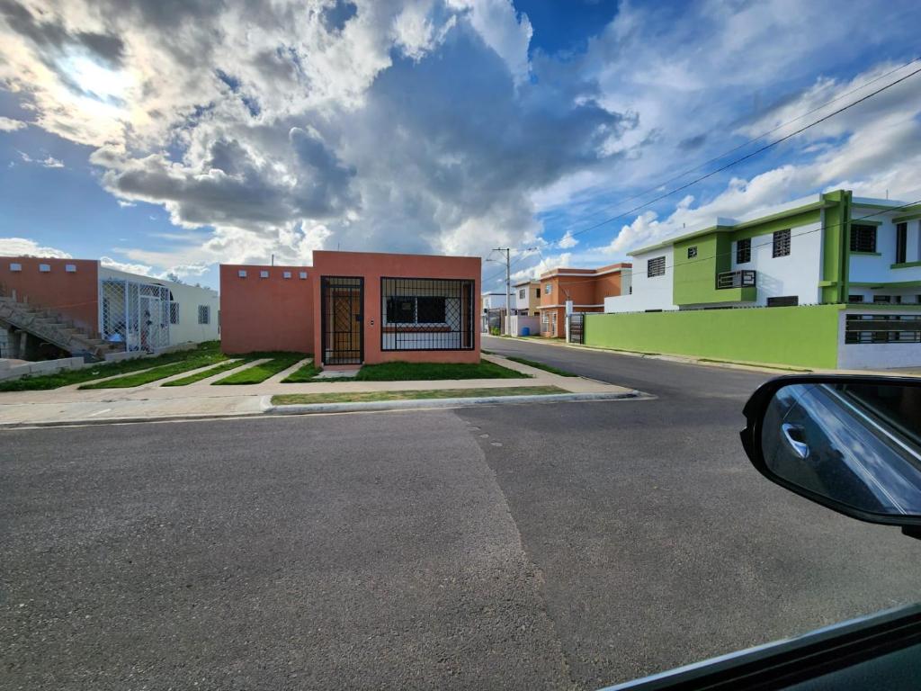 a view from a car of a street with buildings at Amazing Three Bedrooms House in La Romana