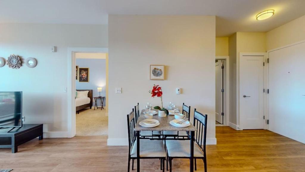 a dining room and living room with a table and chairs at Stylish Home With Free ParkingZA in Stamford