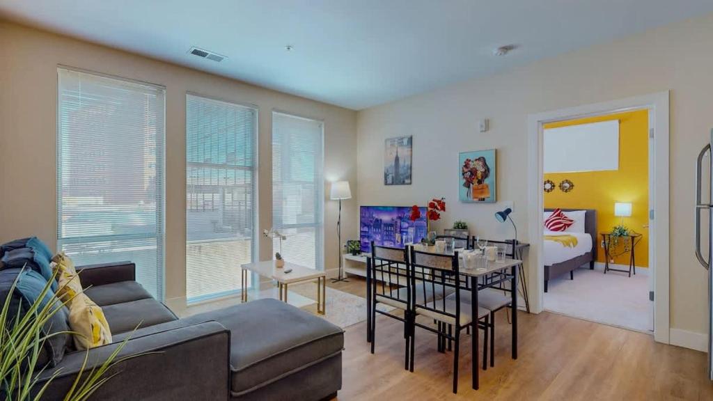 a living room with a couch and a dining room at Stylish Home and Cozy200 in Stamford