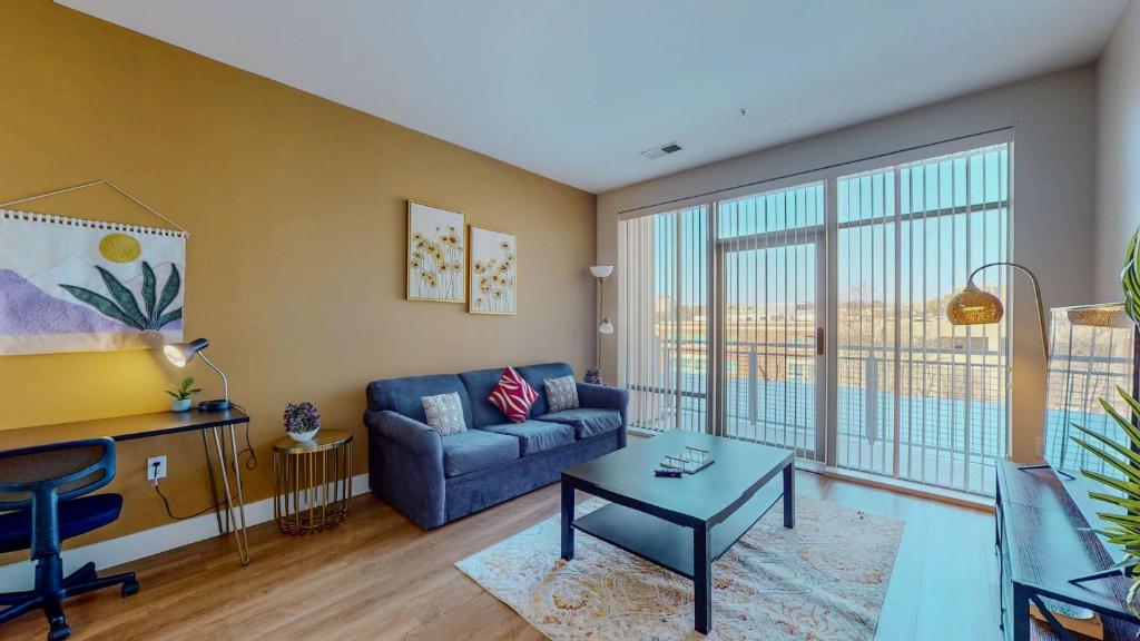 a living room with a couch and a table at Great Charming stay in Stamford
