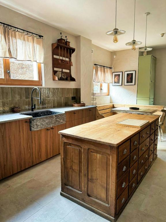 a kitchen with wooden cabinets and a large island at Former Hotel Transformed Into Chalet In Valmorel in Les Avanchers
