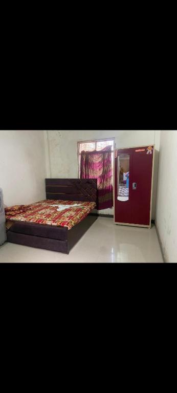 a bedroom with two beds and a door with a window at Mishthi singh homestay in Jalālpur Dhai