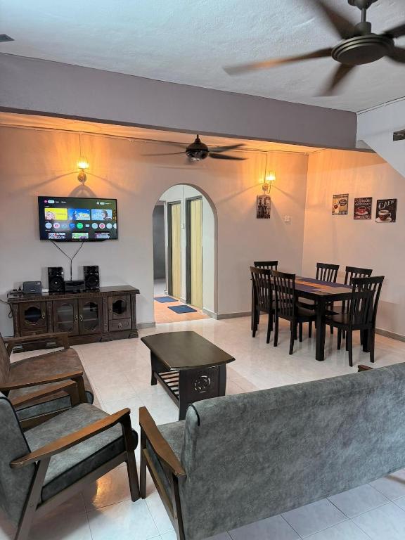 a living room with a couch and a table at PRS Homestay in Chemor