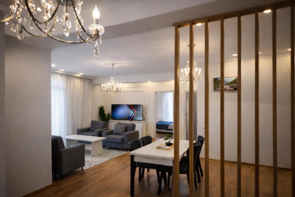 a living room with a table and chairs and a living room at Chill House in Kutaisi