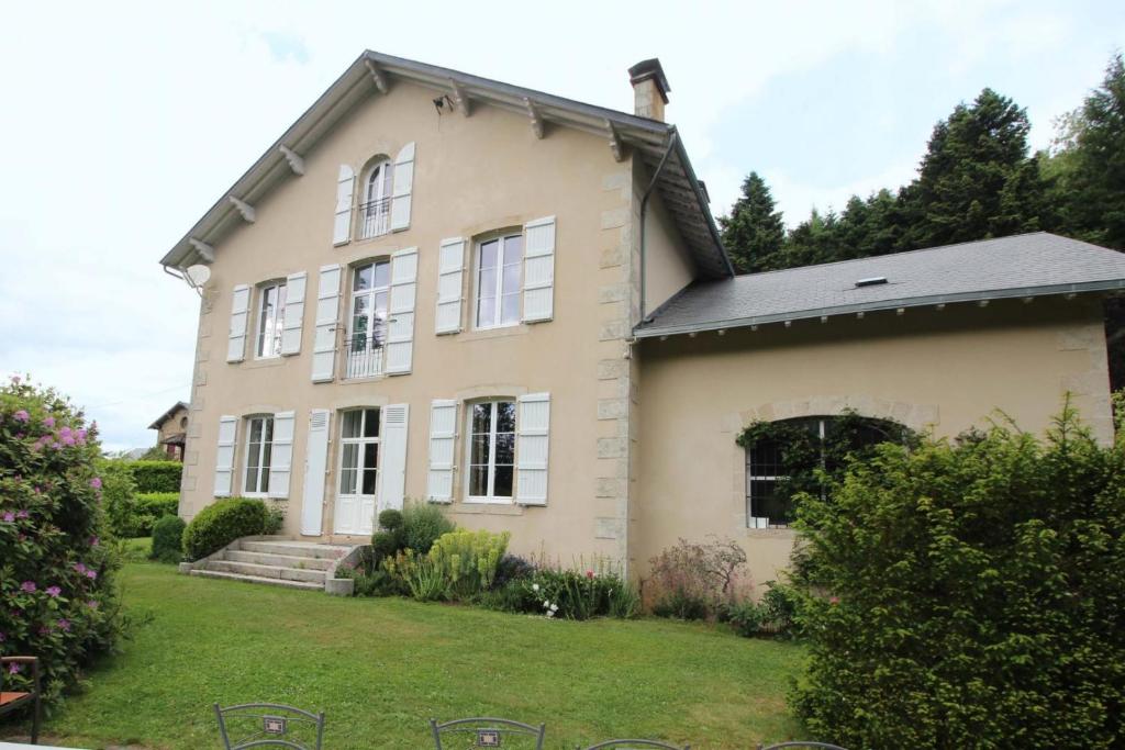 a large white house with a yard at Brenac in Eymoutiers