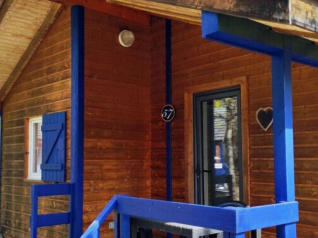a log cabin with a blue staircase in front of a door at Chalet 2 Pers avec Terrasse à Challes-les-Eaux - API-1-52-1283 in Challes-les-Eaux