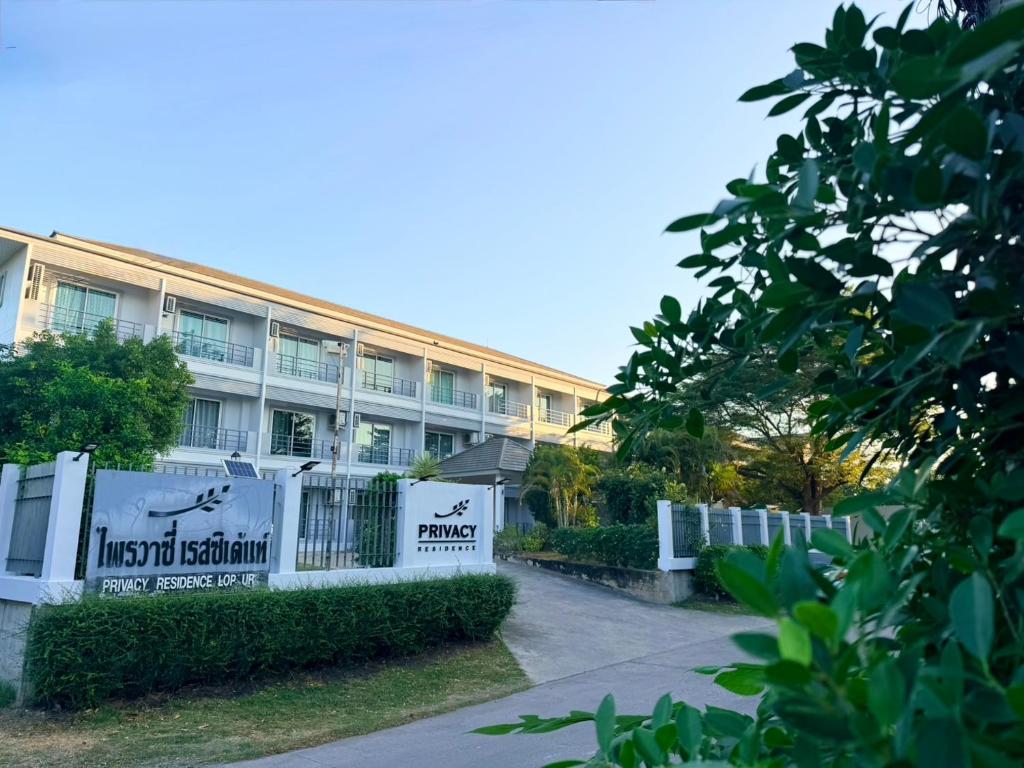 a building with a fence in front of it at Privacy Residence Lopburi in Lop Buri