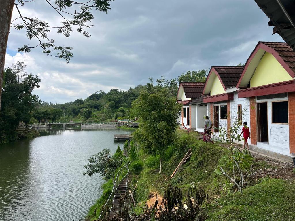 a couple of buildings next to a river at Live lombok homestay in Batukliang