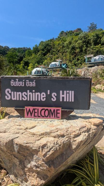 a sign that reads sunithsiths hill welcome at Sunshine's Hill in Ko Lanta