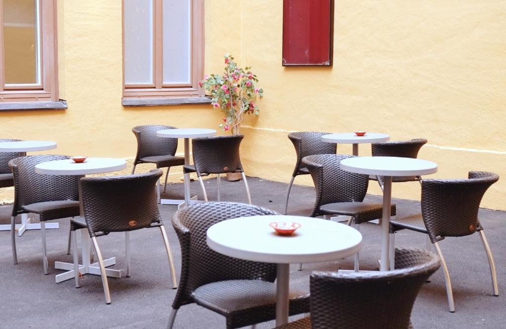a dining room table with chairs and umbrellas at Hotel Hötorget in Stockholm