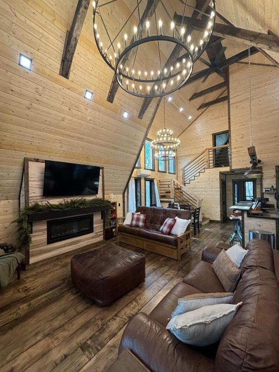 a large living room with a couch and a tv at Eagles Rest in Murray