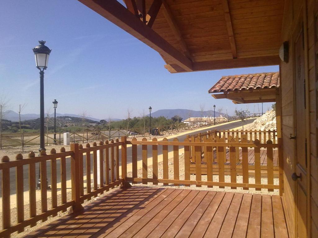 a wooden deck with a view of a road at Complejo Pueblo Blanco in Olvera